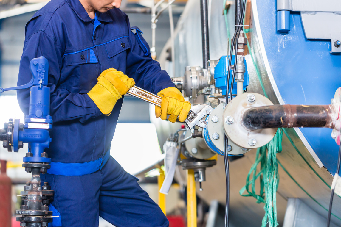 Mechanic Repairing Machine in Industrial Plant